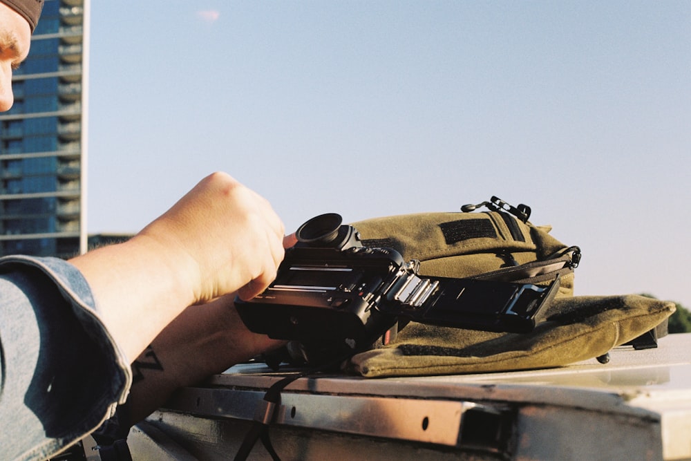 a man sitting on a truck holding a camera