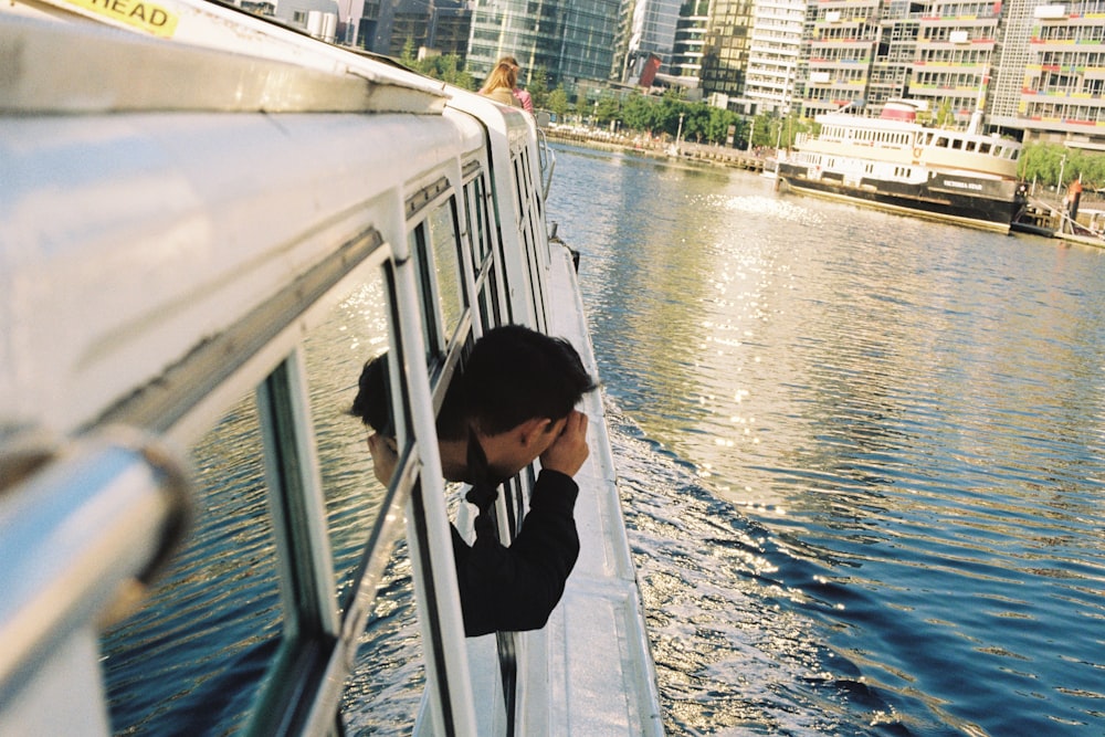a person standing on a boat looking out the window