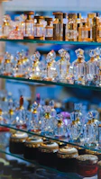 Elegant display of nafees fragrance bottles arranged on a polished wooden shelf.