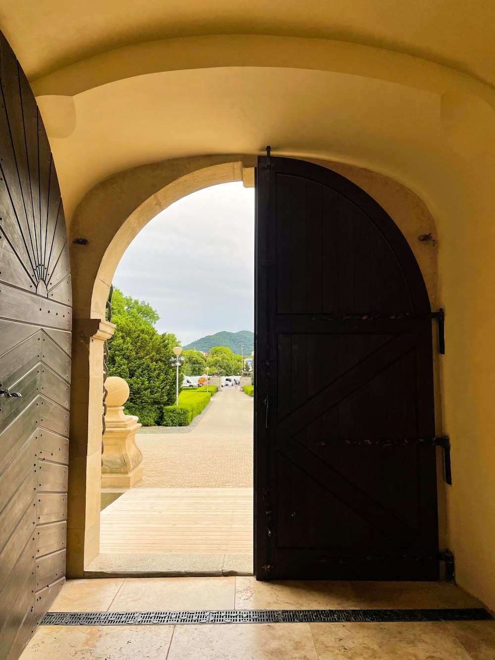 an open door leading to a walkway with a view of mountains