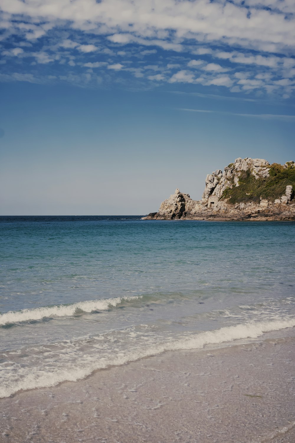 a rocky outcropping in the middle of the ocean