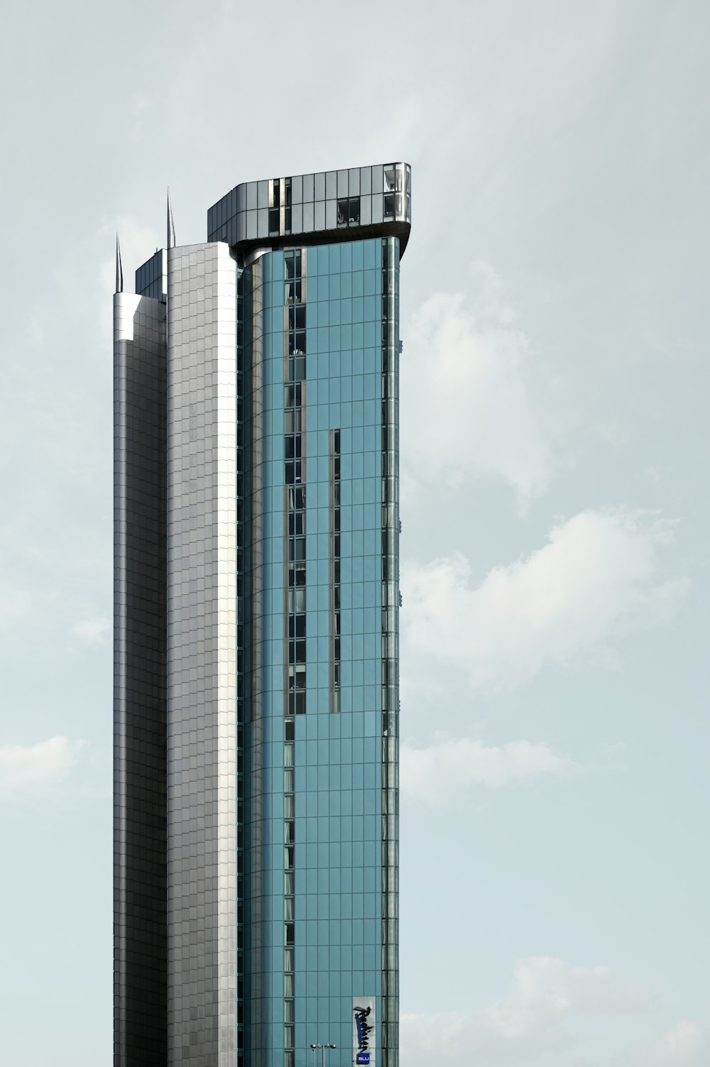 a tall building with a sky background