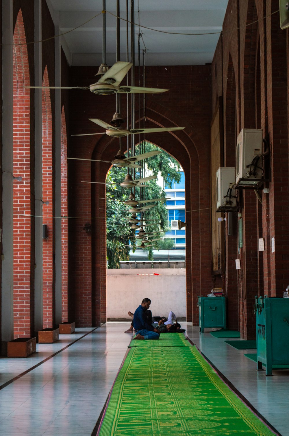 a man sitting on the floor of a building