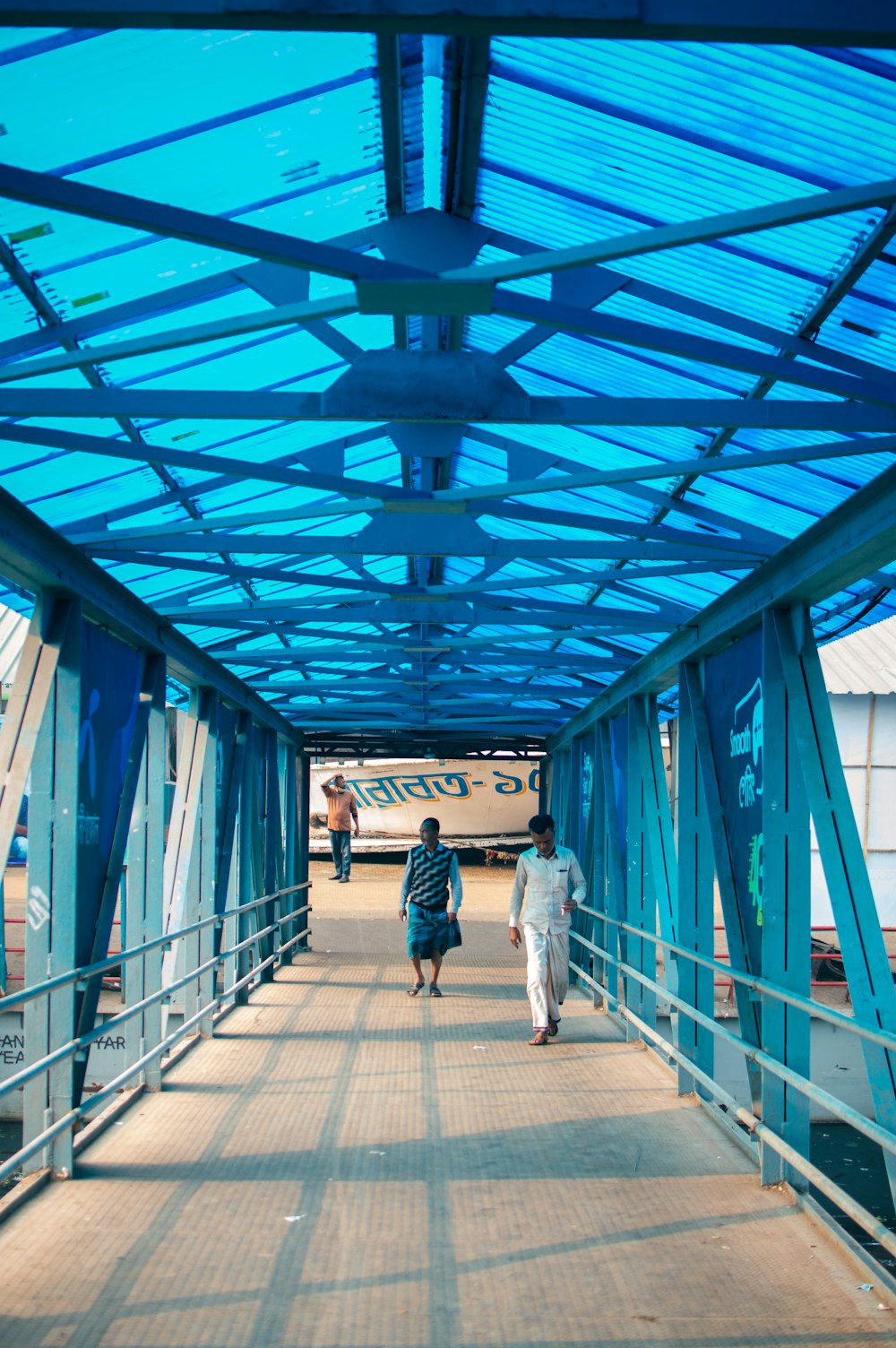 a couple of people walking across a bridge