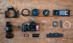 a wooden table topped with different types of cameras