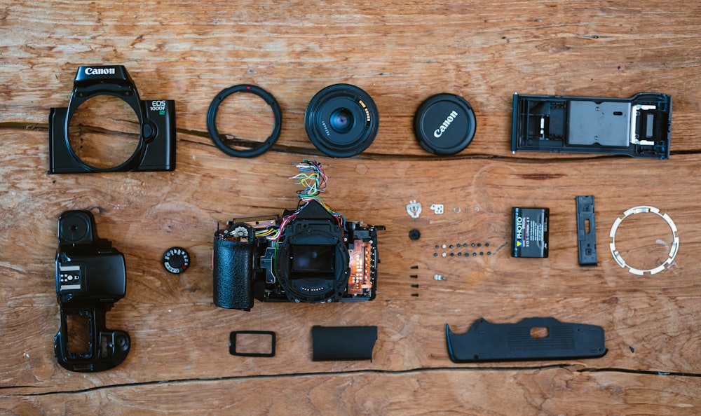 a wooden table topped with different types of cameras