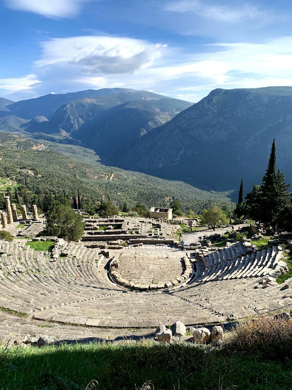 an ancient theatre in the middle of a mountain range
