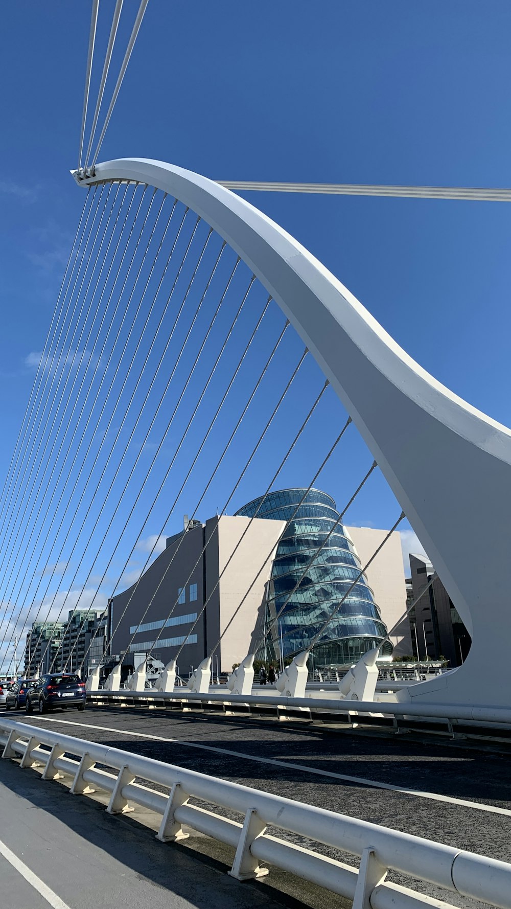 a very tall bridge with a very tall building in the background