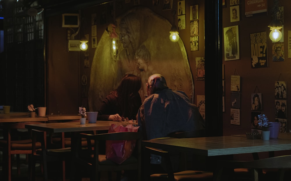 a man and woman sitting at a table in a restaurant