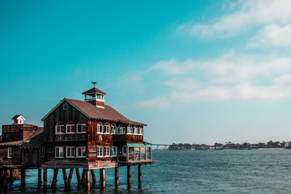 a house on a pier in the middle of the ocean