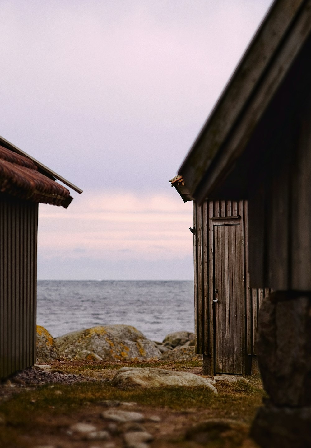 a couple of buildings sitting next to a body of water