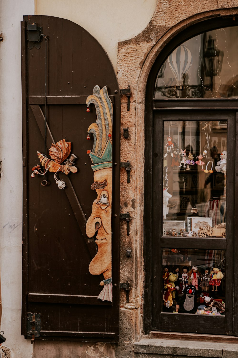 a wooden door with a clock on the side of it