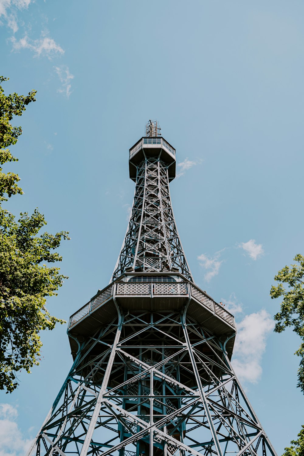 a tall metal tower with a sky background