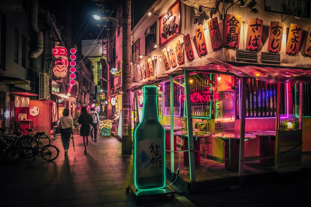 a bottle of beer sitting on the side of a street