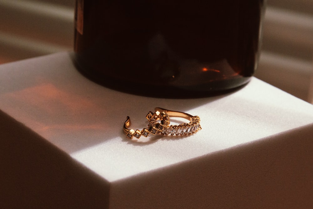 a gold ring sitting on top of a white box