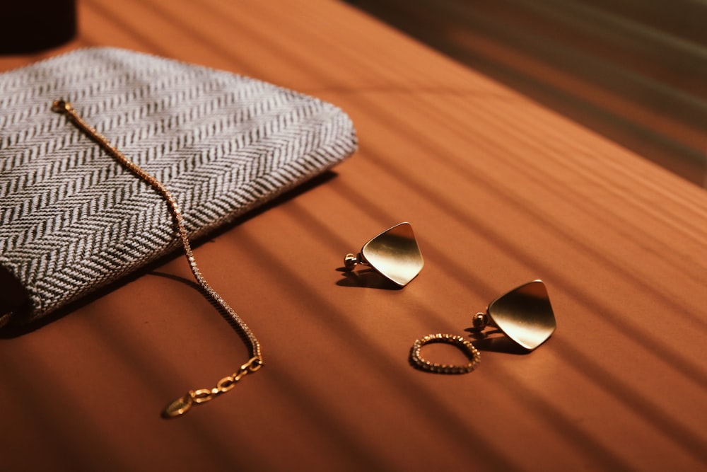 a pair of earrings and a purse on a table