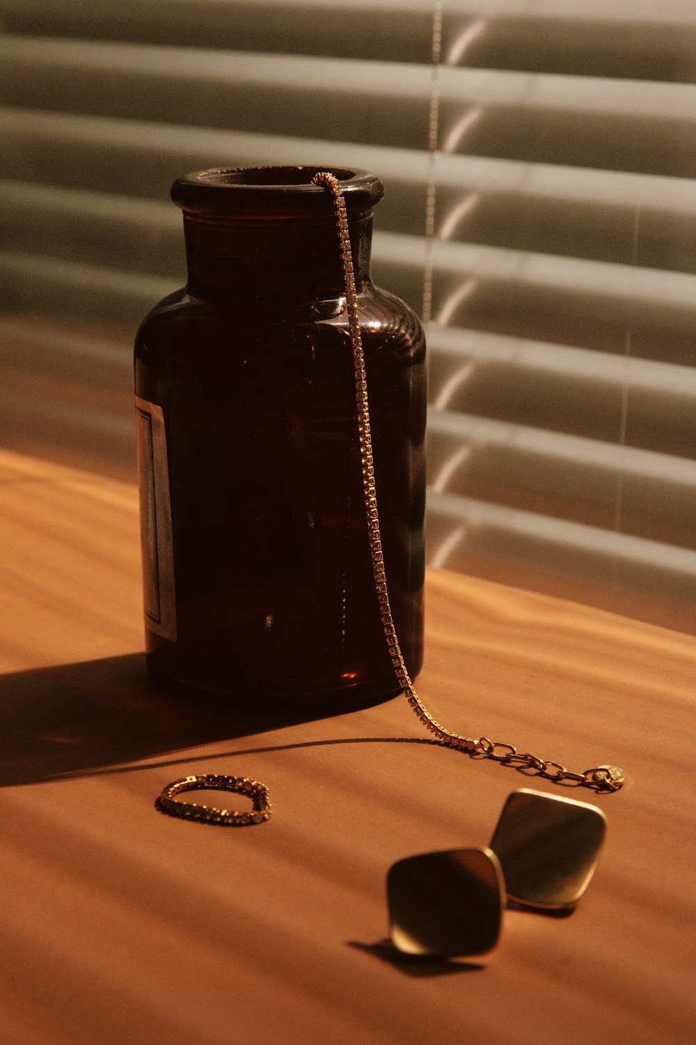 a brown bottle sitting on top of a wooden table