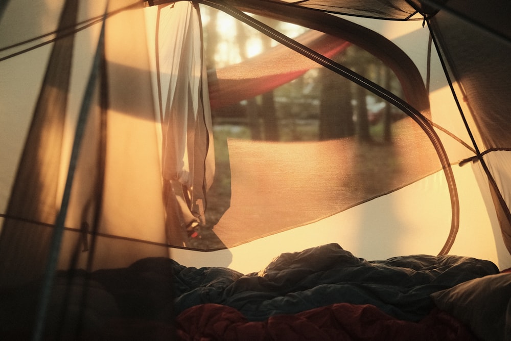 the inside of a tent with a bed inside of it
