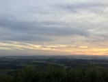 Calm landscape with rolling hills and a clear blue sky at dawn.
