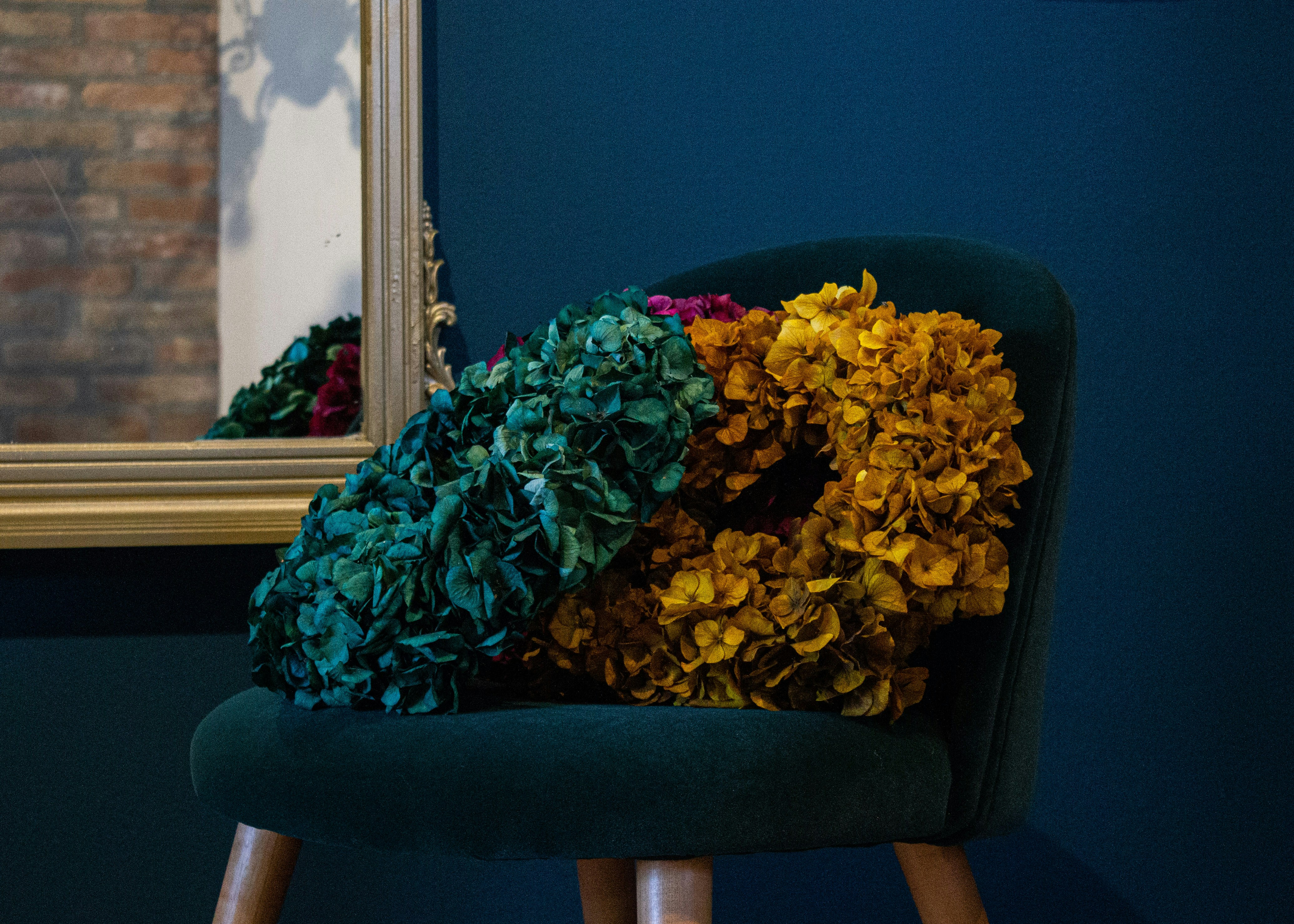 a green chair with a bunch of flowers on it