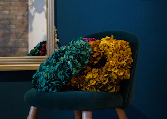 Cozy corner of the Bela Beauty Studio with emerald green walls and elegant gold decor.