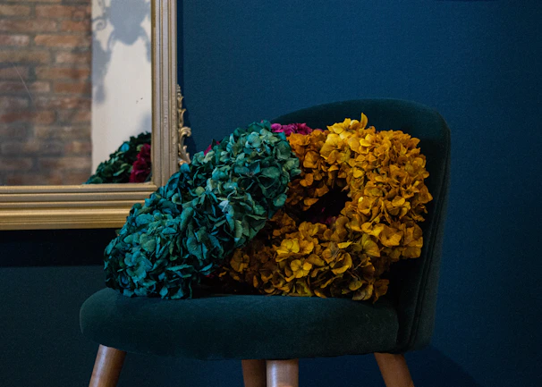 Cozy corner of the Bela Beauty Studio with emerald green walls and elegant gold decor.