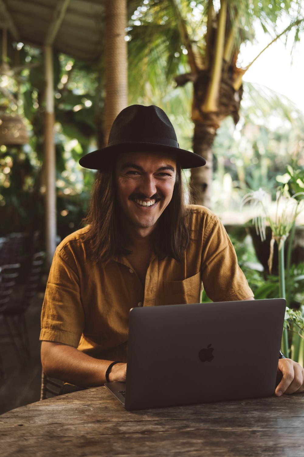 a man sitting at a table with a laptop