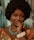 a woman with an afro is posing for a picture