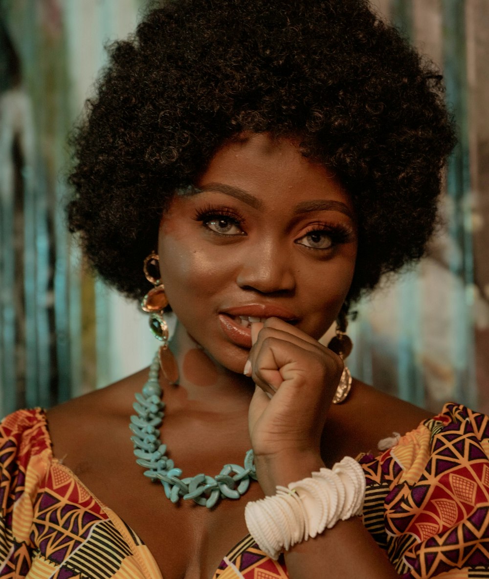 a woman with an afro is posing for a picture