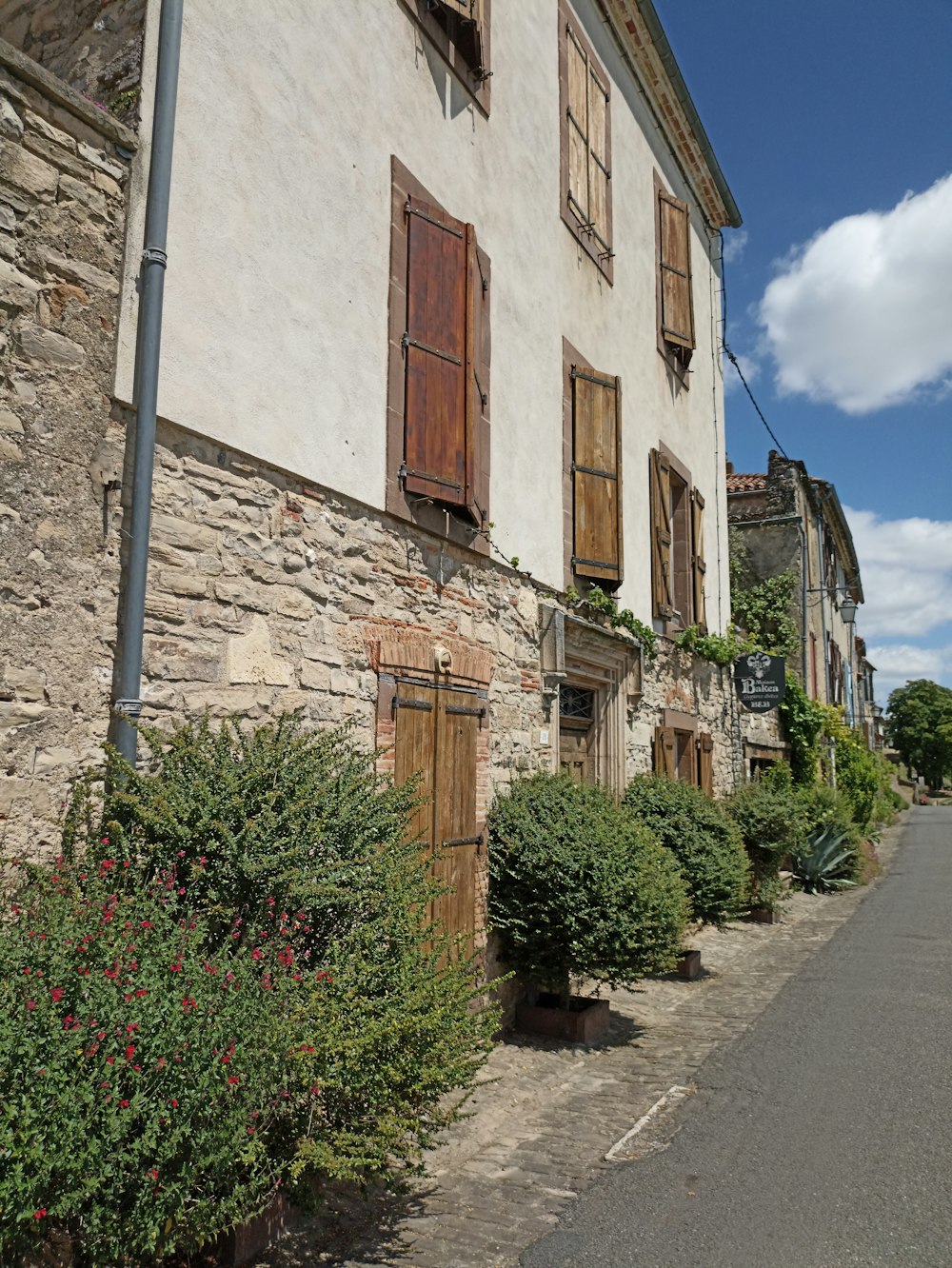 an old building with wooden shutters on the side of it