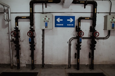 a room with pipes and a sign on the wall