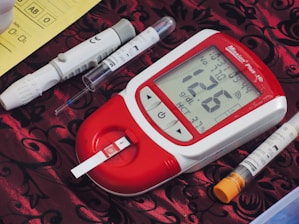 a thermometer, a pen, and two sys on a table