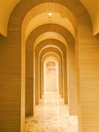 a very long hallway with a clock on the wall
