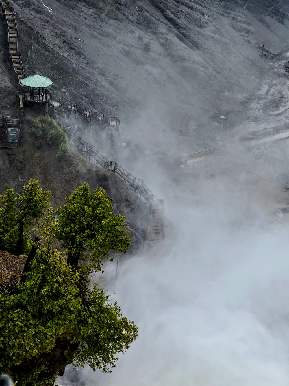 a large amount of steam rising from a mountain