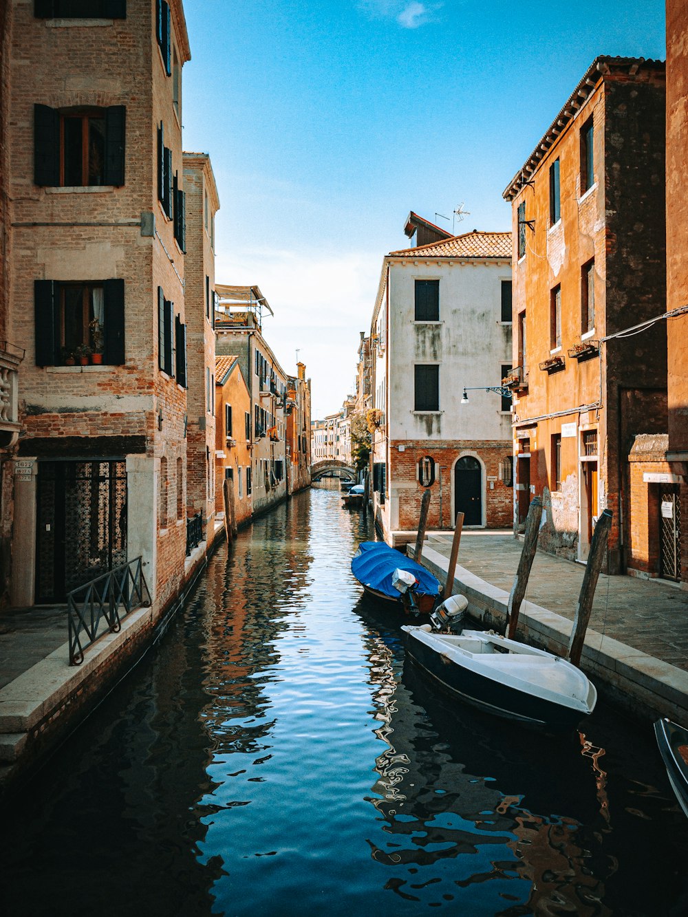 a narrow canal with a few boats in it