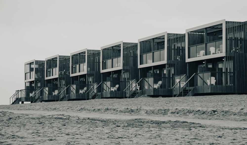 a row of apartment buildings sitting on top of a sandy beach
