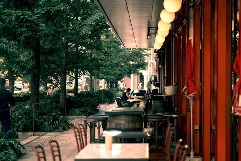 a restaurant with tables and chairs on a sidewalk