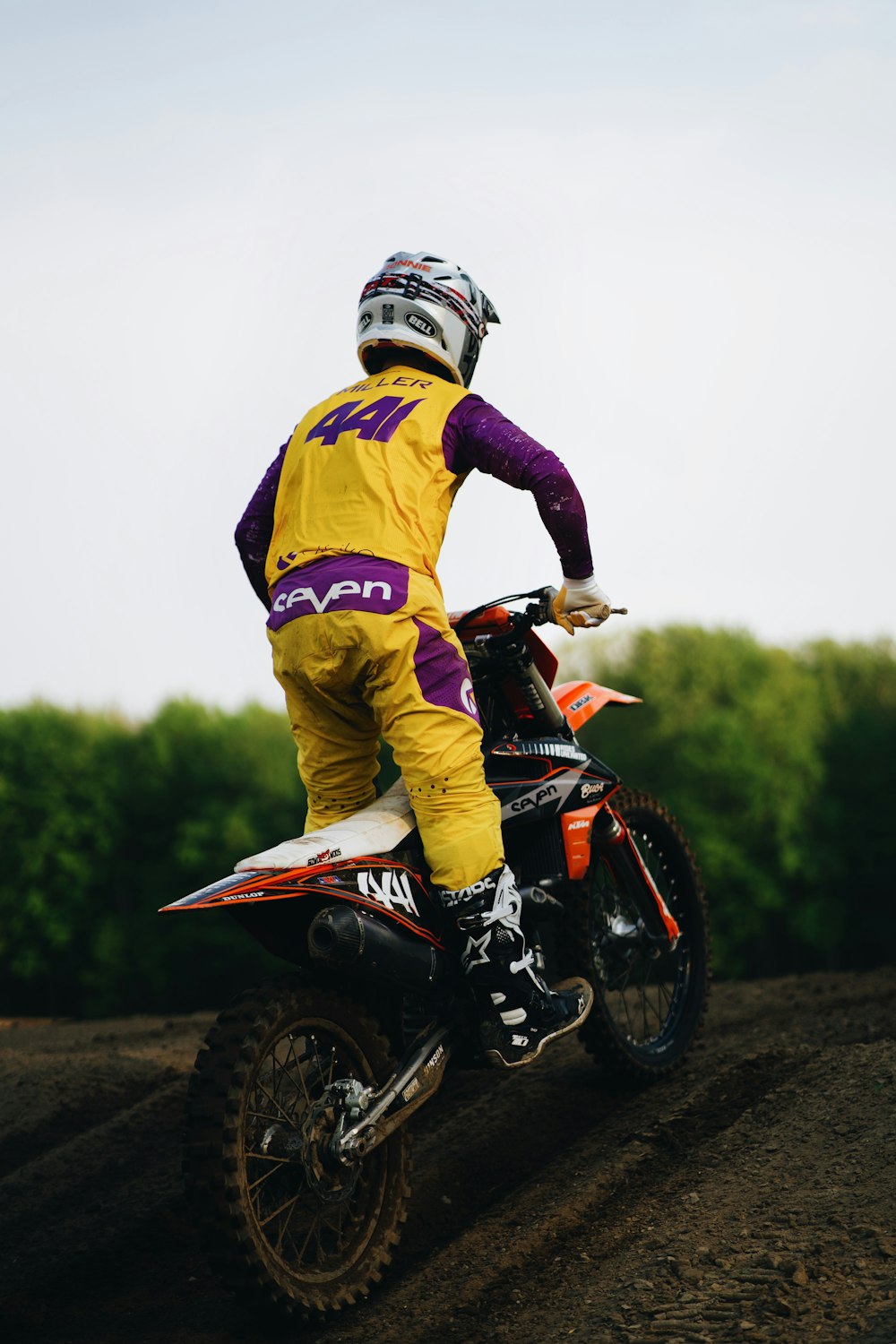 a man riding a dirt bike on top of a dirt field