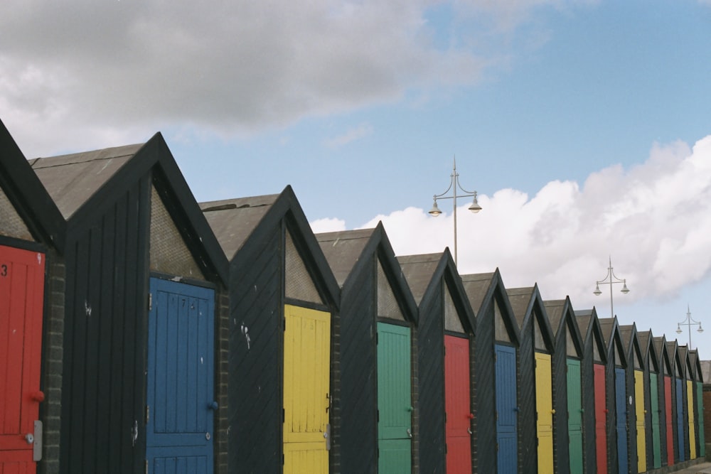 a row of colorful beach huts sitting next to each other