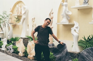 An outdoor installation of mixed media sculptures surrounded by greenery.