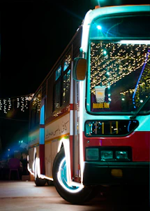 A sleek party bus with vibrant interior lighting ready to host a joyful group celebration at night.