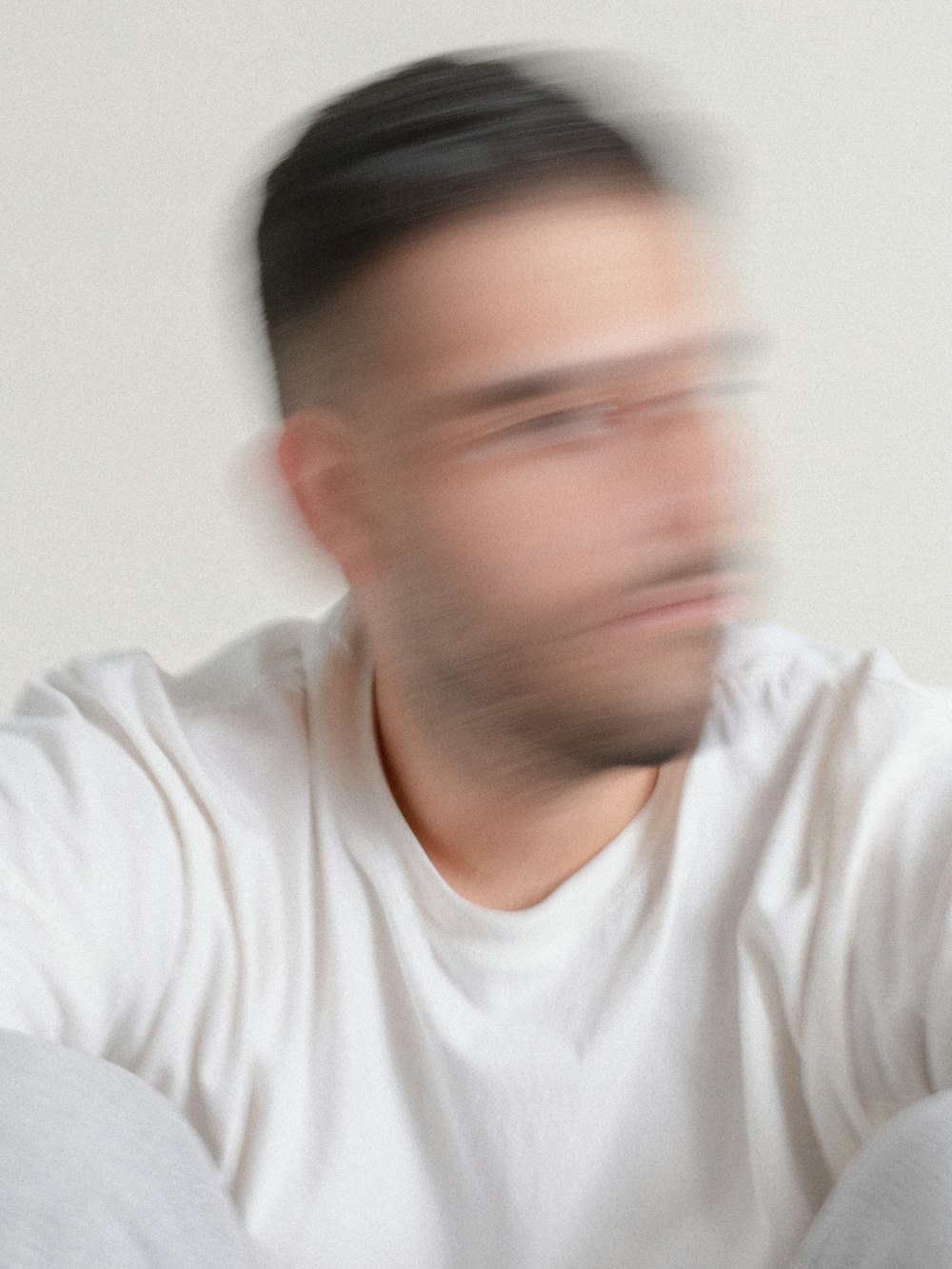 a blurry image of a man in a white shirt