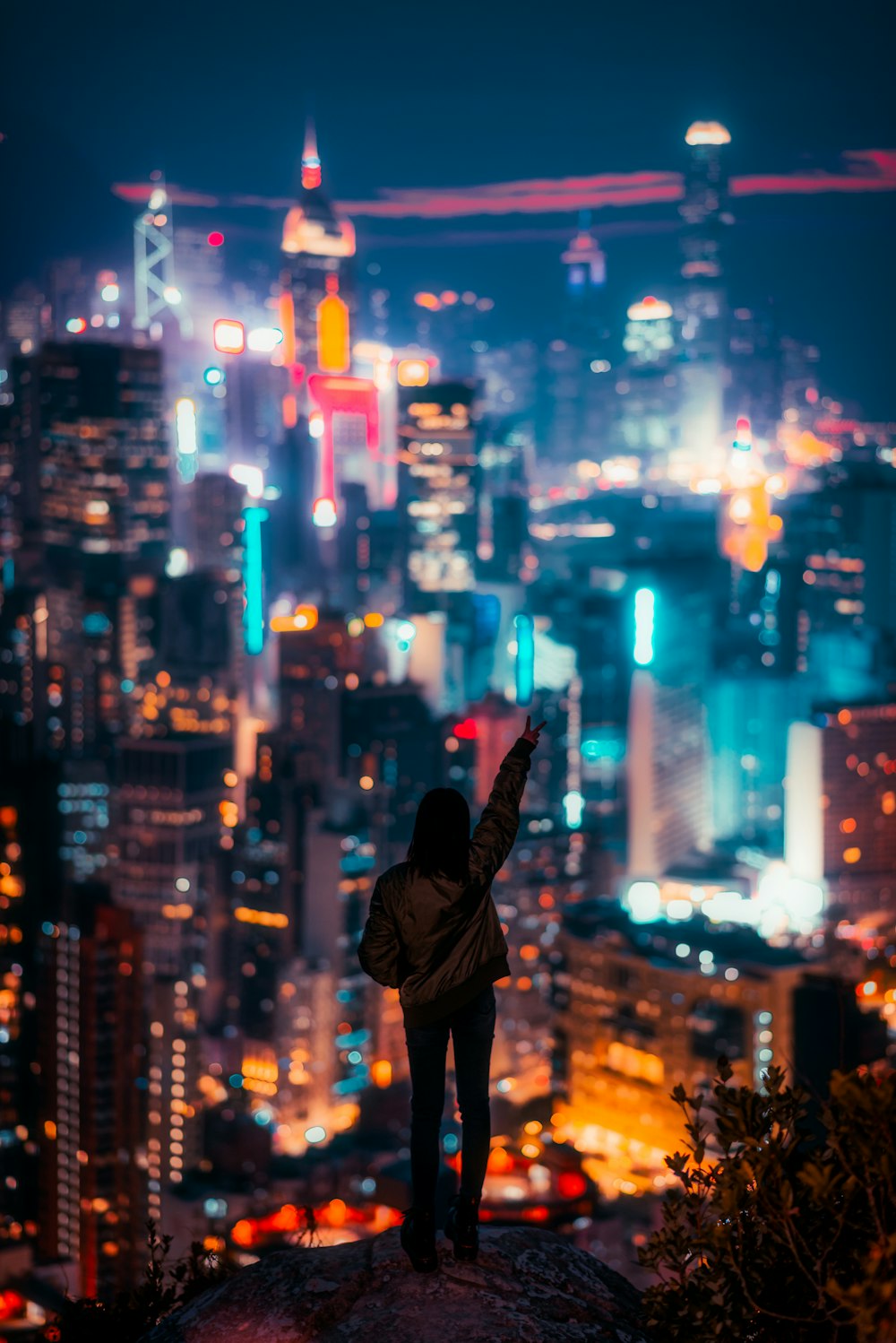 a person taking a picture of a city at night