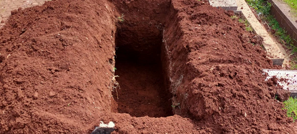 Close-up photo of a freshly marked loteviva plot with visible soil and measuring stakes