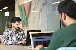 a man sitting in front of a laptop computer