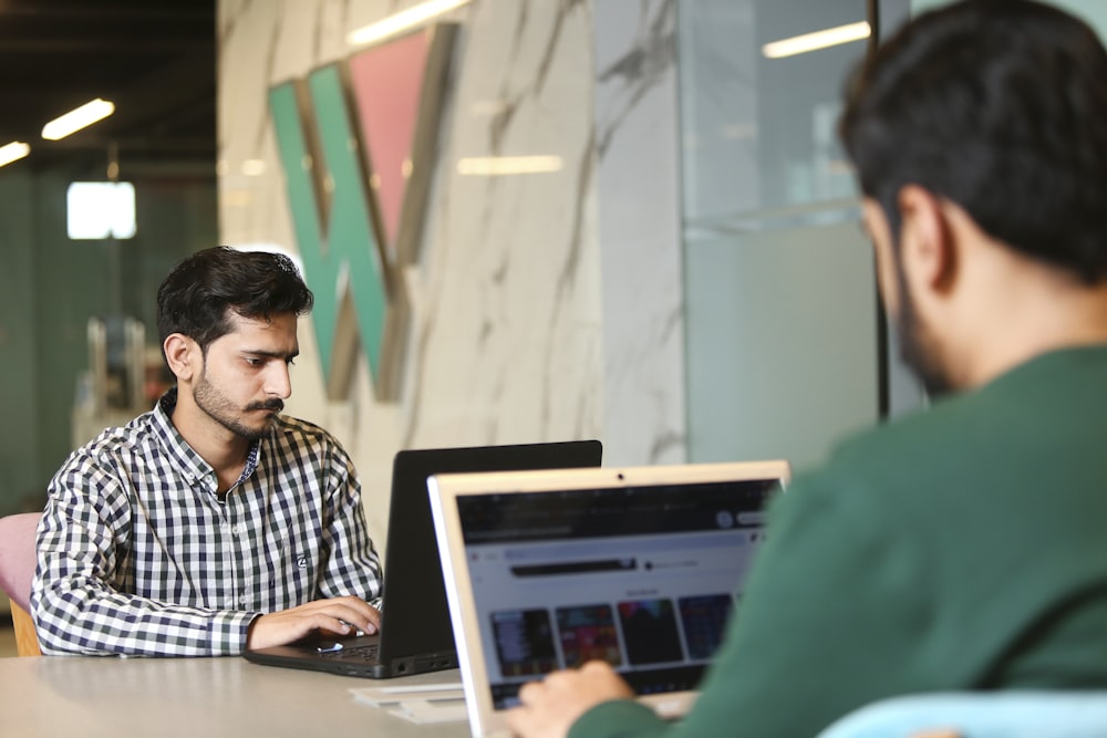 a man sitting in front of a laptop computer