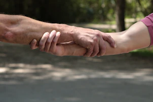 a close up of two people holding hands