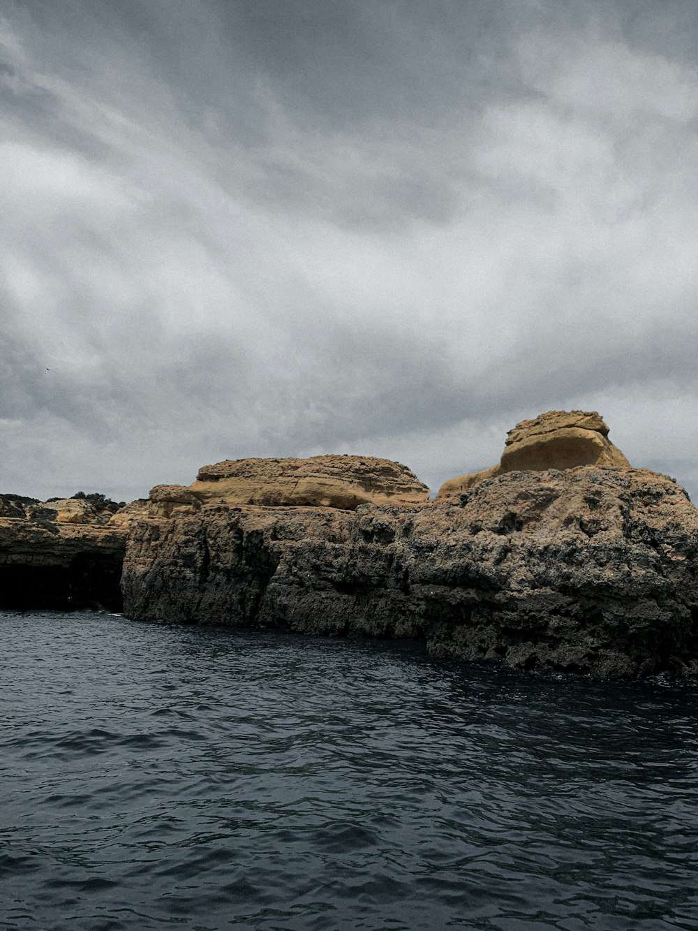 a rock formation in the middle of a body of water