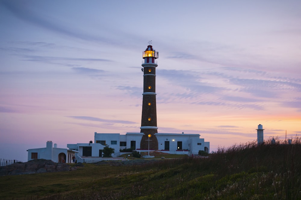 a light house sitting on top of a hill