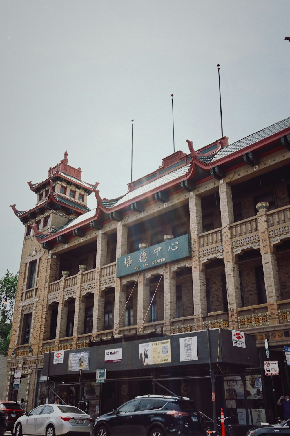 a large building with a lot of cars parked in front of it